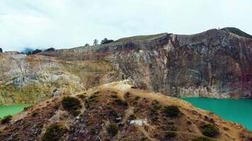 Experience the mesmerizing of Kelimutu's Three Color Lake in Ende. Wrapped in mystical clouds, this magical site, rich in legend, offers a breathtaking landscape that captivates the soul. video