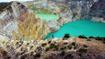 Experience the mesmerizing of Kelimutu's Three Color Lake in Ende. Wrapped in mystical clouds, this magical site, rich in legend, offers a breathtaking landscape that captivates the soul. video