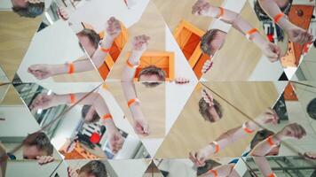 Boy's hands guestures in many parts of kaleidoscope reflection. Geometric design of a happy child playing on the background of mirror in kaleidoscope video