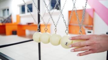 Newton's cradle showing laws of physics in motion. Museum of Science and newton pendulum video