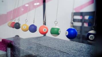 Newton's cradle showing laws of physics in motion. Museum of Science video
