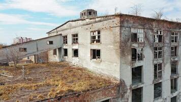 Aerial view of an old factory ruin and broken windows. Old industrial building for demolition. video