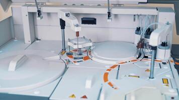Modern robotic machine of checking blood samples in process in the laboratory. Analysis of liquid at medical clinic. Reseach and science concept. Slow motion. video
