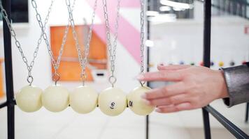 Newton's cradle showing laws of physics in motion. Museum of Science and newton pendulum video