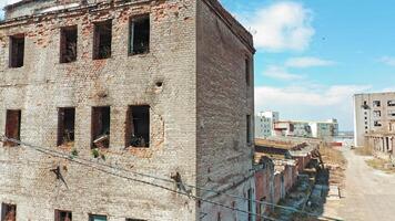 Ruined building without windows and roof outside. Exterior of a broken-down building in the desolate part of the city. video