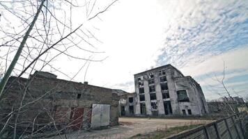 Desolate place with ruined empty buildings outdoors. Gray abandoned buildings without windows after military actions. video