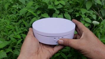 Rotating display stand shown by a person. Podium for small products. Small round stage that rotates. 4k footage video