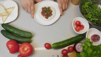 Steak tartare is masterpiece of culinary skill, served with sour cream-based white sauce, garnished with herbs and garlic, surrounded by ingredients and vegetables video