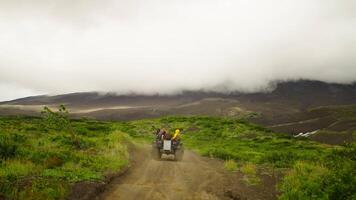 Traveling In Nature By Monster Quad, Tourists Riding Mud Quad, Back View, Clouds At Top Of Mounts video