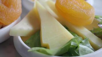 Savor the Delightful Cheese and Salad Platter accompanied by an Array of Sweet Fruits video