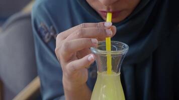 A Refreshing Yellow Beverage Served with a Straw in a Detailed CloseUp View for Enjoyment video