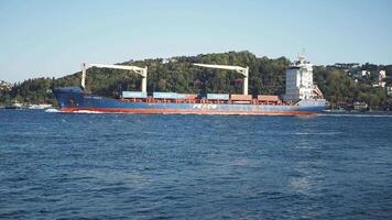 turkey istanbul 23 august 2024, A large cargo ship is skillfully navigating through calm waters, close to the beautiful shoreline video