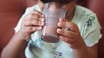 A Child Happily Enjoying a Delicious Chocolate Drink in a Cozy and Comfortable Setting video