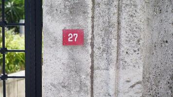 House Number 27 beautifully displayed on a Concrete Wall, adding character to the location video