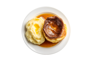 Yorkshire pudding with mashed potatoes and gravy on a plate isolated on a transparent background png