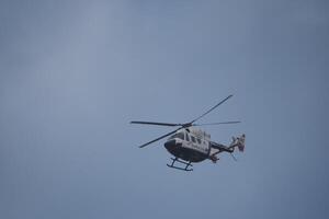 VALENCIA, SPAIN OCTOBER 31, 2024. Rescue helicopter flying during emergency flood operations in Valencia photo