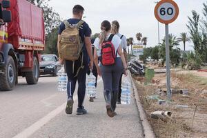 VALENCIA, SPAIN OCTOBER 31, 2024. Volunteers are bringing drinking water to people affected by the floods in Valencia photo
