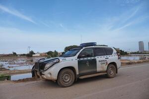 VALENCIA, SPAIN OCTOBER 31, 2024. Spanish guardia civil patrolling flooded fields in Valencia after heavy rains and flood photo