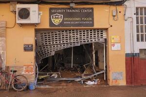 VALENCIA, SPAIN OCTOBER 31, 2024. Broken security gate and debris covering the floor of a flooded security training center in Valencia after heavy rainfall photo