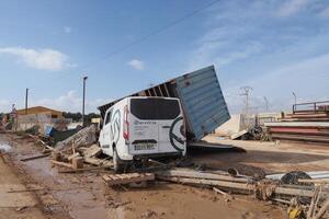 VALENCIA, SPAIN OCTOBER 31, 2024. Devastating consequences of flooding showing overturned truck and van in Valencia, Spain photo