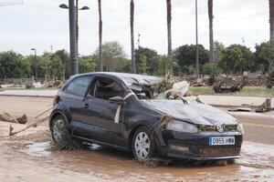 VALENCIA, SPAIN OCTOBER 31, 2024. Wrecked car illustrating the devastating consequences of flooding in Valencia, Spain photo