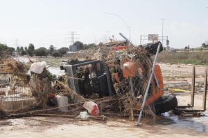 VALENCIA, SPAIN OCTOBER 31, 2024. Debris and mud covering a forklift in Valencia, Spain, after severe flooding, highlighting the destructive impact of the natural disaster photo