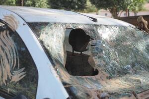 VALENCIA, SPAIN OCTOBER 31, 2024. Broken windshield of a mud covered car, highlighting the destructive impact of the recent floods in Valencia photo