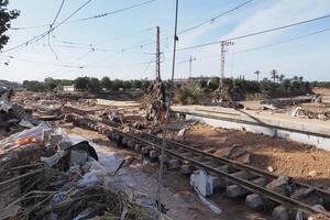 VALENCIA, SPAIN OCTOBER 31, 2024. Destroyed railway tracks and debris scattered across the landscape after a severe flood in Valencia, Spain photo