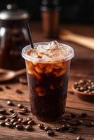 cold coffee in a transparent plastic cup, presented on an old wooden table with scattered coffee beans and vintage kitchen utensils photo
