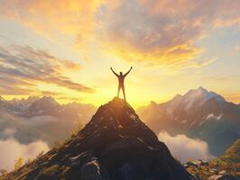 A man standing on top of a mountain with his arms raised photo