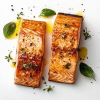 A fresh, raw salmon fillet seasoned with herbs and spices on a white background, highlighting the vibrant orange color and texture of the fish photo