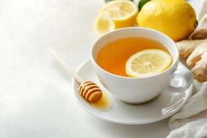 A soothing cup of ginger tea with lemon and honey on a light background, ideal for product placement and text overlay photo