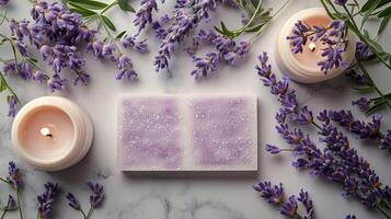 Lavender flowers and candles on a marble surface photo