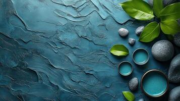 Spa stones and green leaves on a blue background photo