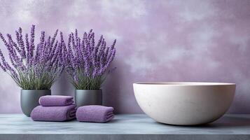 Lavender flowers in a vase and a bowl with towels photo