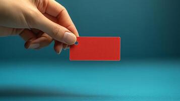 A person holding a red card on a blue background photo