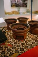 A traditional clay griddle for making surabi, showcasing its rustic design and earthy texture photo