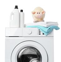 White Laundry Detergent Bottles, Sheep Toy, and Towels on Top of a White Washing Machine photo