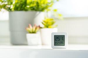 White Digital Thermometer Displaying Room Temperature and Humidity photo