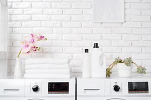 Two White Front Loading Washing Machines in Modern Laundry Room photo