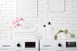 Two White Front Loading Washing Machines in Modern Laundry Room photo