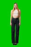 Young Woman With Surprised Expression in Front of Green Screen photo