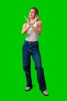 Woman Crossing Arms In Front Of Green Screen photo