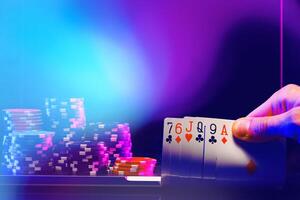 Hand of Cards and Stacks of Poker Chips in a Casino Setting photo