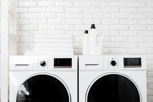 Two White Front Loading Washing Machines in Modern Laundry Room photo