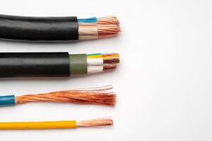 Various Electrical Wires With Exposed Copper Strands on White Background photo