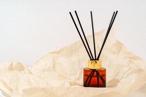 Brown Glass Reed Diffuser on Crumpled Paper photo