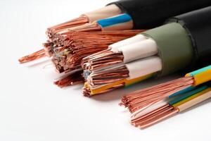 Various Electrical Wires With Exposed Copper Strands on White Background photo