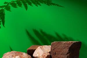 Stone display for product against green background photo