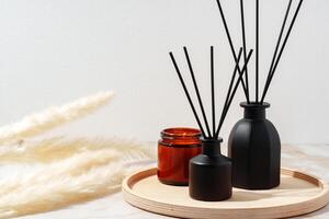 Black Reed Diffuser and Amber Candle on Wooden Tray photo